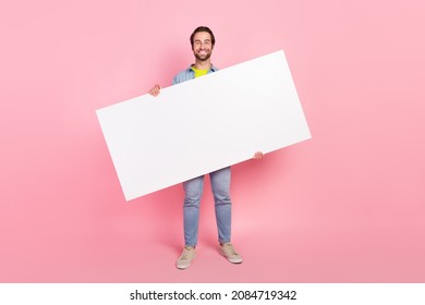 Full size photo of young cheerful man hold empty paper card advertise isolated over pink color background - Shutterstock ID 2084719342