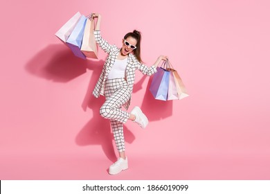 Full Size Photo Of Young Crazy Excited Girl Have Fun Hold Bags Shopper Buy Wear Plaid Jacket Pants Isolated Over Pastel Color Background