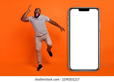 Full Size Photo Of Young Excited African Man Good Mood Carefree Chill Event Isolated Over Orange Color Background