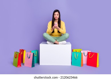 Full Size Photo Of Young Girl Sit Podium Use Mobile Share Repost App Download Isolated Over Violet Color Background