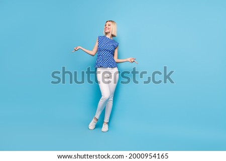 Full size photo of young girl happy positive smile have fun party dance isolated over blue color background