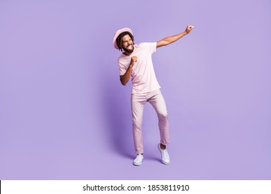 Full size photo of young handsome afro crazy excited happy man guy dancing look copyspace isolated on purple color background