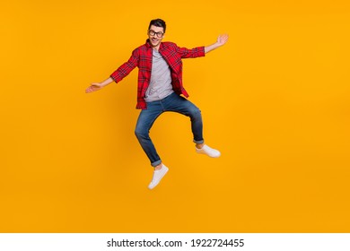 Full size photo of young happy excited smiling positive man in glasses jumping isolated on yellow color background - Powered by Shutterstock