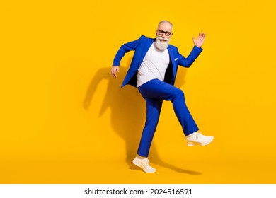 Full size photo of young happy good mood cheerful businessman dancing having fun isolated on yellow color background