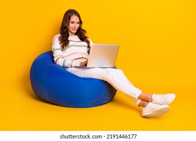 Full Size Photo Of Young Interested Happy Girl Sitting Chair Working Distance Online Programmer Isolated On Yellow Color Background