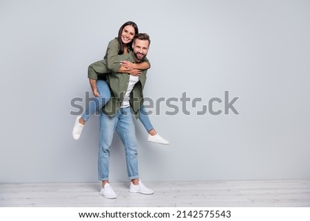 Full size photo of young lovely couple soulmate have fun romantic isolated over grey color background
