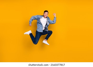 Full Size Photo Of Young Man Jump Run Rush Shopping Carerfee Wear Casual Clothes Isolated Over Yellow Color Background