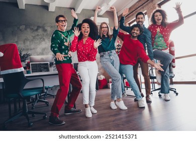 Full size photo of young people team employees raise hands cheerful enjoy cozy christmas decoration interior office indoors corporate party - Powered by Shutterstock