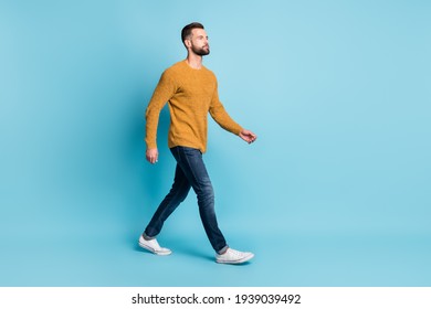 Full size photo of young serious cool attractive handsome man go walk look copyspace isolated on blue color background - Powered by Shutterstock