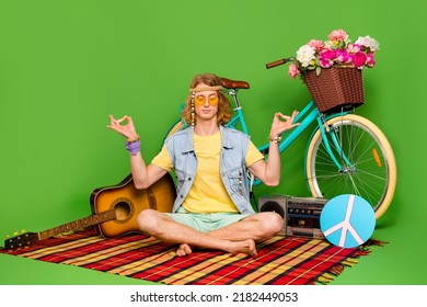 Full Size Portrait Of Focused Calm Hippy Guy Sit Checkered Blanket Meditate Isolated On Green Color Background