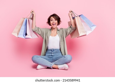 Full size portrait of funky positive girl hands hold raise packages isolated on pink color background