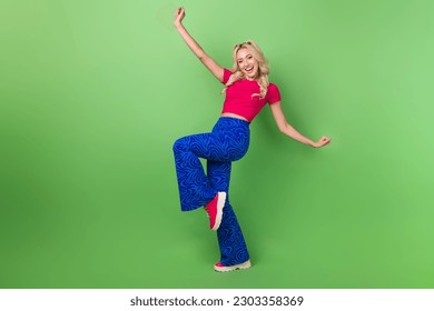 Full size portrait of gorgeous positive girl have fun dancing rejoice isolated on green color background - Powered by Shutterstock