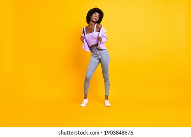 Full size portrait of nice dark skin person look empty space enjoy dancing wear purple isolated on yellow color background