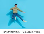 Full size portrait of sportive excited person jump air battle hands legs kick isolated on blue color background