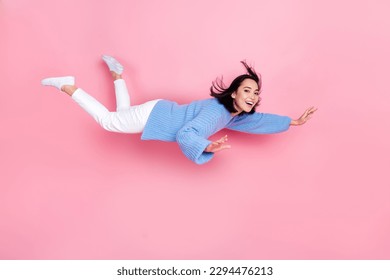 Full size profile photo of cheerful peaceful girl flying levitate isolated on pink color background