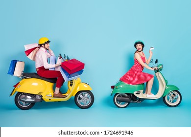 Full Size Profile Photo Of Crazy Shopaholic Lady Giving Credit Card Assistant Guy Drive Retro Moped Carry Packs Shopping Abroad Vintage Clothes Protective Caps Isolated Blue Color Background