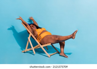 Full size profile photo of excited funky curvy shape lady have fun sit rest no filters isolated on blue color background