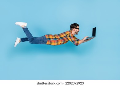 Full Size Profile Photo Of Flying Person Use Netbook Write Email Isolated On Blue Color Background