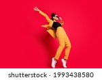 Full size profile photo of funny lady dance wear eyewear yellow suit isolated on vivid red color background