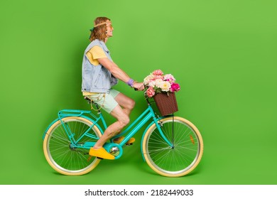 Full Size Profile Photo Of Handsome Hippy Guy Driving Bike Look Empty Space Isolated On Green Color Background