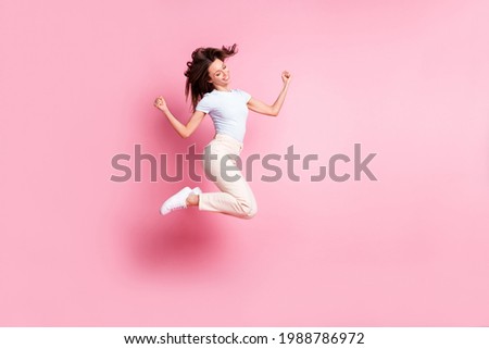 Full size profile photo of hooray nice brunette hair lady jump wear t-shirt pants isolated on pink background
