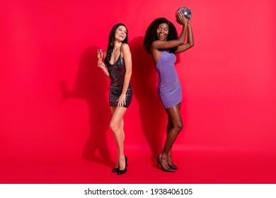 Full size profile photo of impressed brunette ladies with disco ball glass wear dress stilettos isolated on red color background