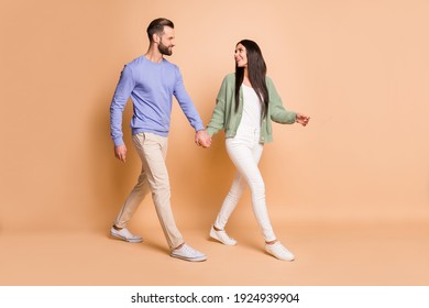 Full size profile photo of optimistic couple go look wear sweater isolated on beige color background - Shutterstock ID 1924939904