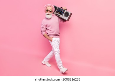 Full Size Profile Photo Of Optimistic Grey Hair Old Man Go With Boom Box Wear Eyewear Sweater Isolated On Pink Background