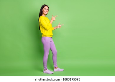 Full size profile portrait of charming cheerful person indicate fingers empty space isolated on green color background - Shutterstock ID 1883195593