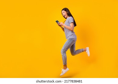 Full Size Profile Portrait Of Charming Person Jump Hold Telephone Chatting Isolated On Yellow Color Background