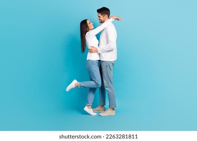 Full size profile portrait of two lovely peaceful partners hug look each other isolated on blue color background - Shutterstock ID 2263281811