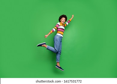 Full Size Profile Side Photo Of Funny Funky Afro American Girl Superhero Concept Jump Fly Motivation Stretch Arms Fist Reach Discount Wear Bright Shine Outfit Isolated Green Color Background