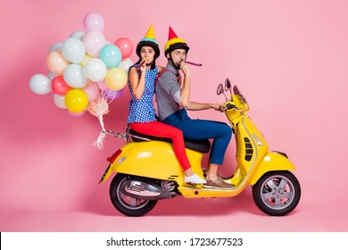 Full size profile side photo funny carefree two people motorcyclists driver drive fast speed motorbike whistle blower travel anniversary event have air baloons fly isolated pink color background