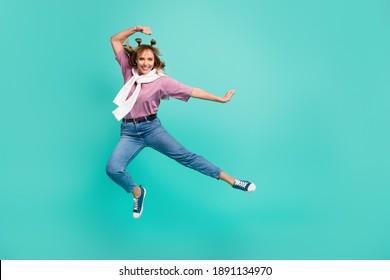 Full size profile side photo of young lovely pretty cheerful positive girl jump does karate isolated on turquoise color background