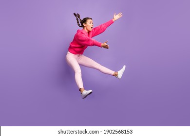 Full size profile side photo of young attractive beautiful girl jumping look copyspace catching isolated on purple color background - Shutterstock ID 1902568153