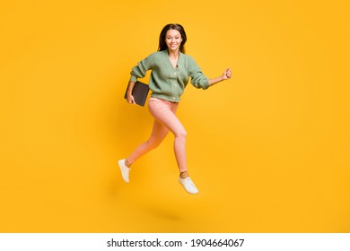 Full size profile side photo of young happy positive good mood girl run in air with laptop isolated on yellow color background - Shutterstock ID 1904664067