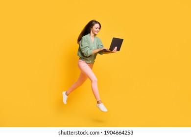 Full Size Profile Side Photo Of Young Happy Cheerful Smiling Girl Run In Air Work In Laptop Isolated On Yellow Color Background