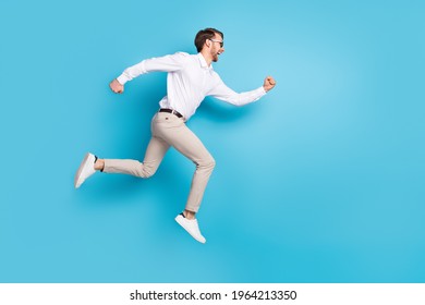 Full Size Profile Side Photo Of Happy Amazed Young Man Run Jump Up Empty Space Sale Isolated On Blue Color Background