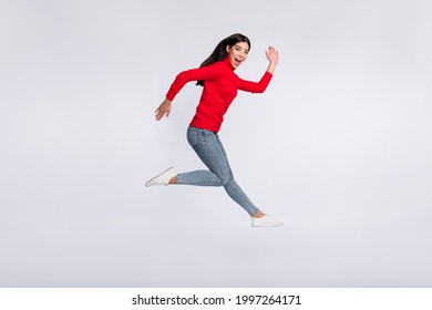 Full Size Profile Side Photo Of Happy Excited Good Mood Asian Girl Running Fast In Air Isolated On Grey Color Background