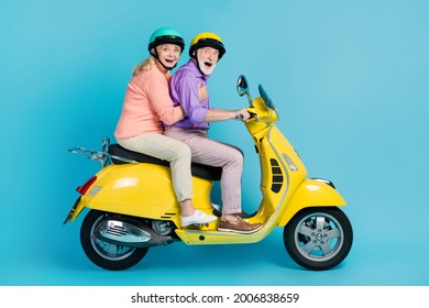 Full Size Profile Side Photo Of Happy Cheerful Old Couple Ride Bike Journey Isolated On Pastel Blue Color Background