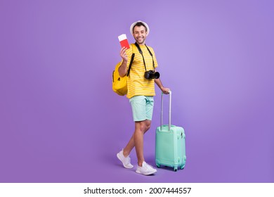 Full Size Profile Side Photo Of Young Man Happy Positive Smile Travel Abroad Tickets Bag Isolated Over Violet Color Background