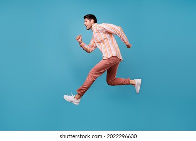 Full Size Profile Side Photo Of Young Man Happy Positive Smile Jump Run Hurry Sale Isolated Over Blue Color Background