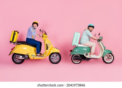 Full Size Profile Side Photo Of Happy Mature Couple In Helmet Casual Style Ride Moped Summer Vacation Isolated On Pink Color Background