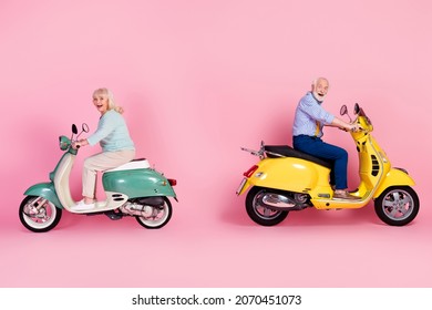 Full Size Profile Side Photo Of Happy Excited Mature Man And Woman Riding Moped Isolated On Pink Color Background