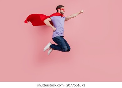 Full size profile side photo of young strong power safety jump up ready to help isolated over pink color background