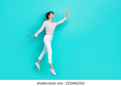 Full Size Profile Side Photo Of Cheerful Positive Lady Wear Stylish Trendy Clothes Jump Hold Empty Space Isolated On Cyan Color Background