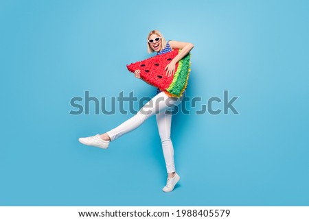 Full size profile side photo of young girl happy positive smile hold big watermelon slice fruit isolated over blue color background