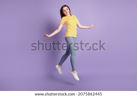 Full size profile side photo of young pretty girl good mood jump go walk isolated over purple color background