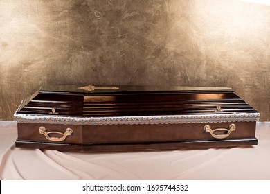 
Full size wooden brown coffin on gold coffin background