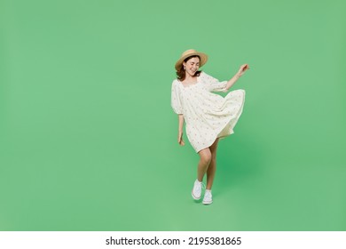 Full Size Young Happy Smiling Charming Cute Woman She 20s Wears White Clothes Hat Play With Fluttering Dress Isolated On Plain Pastel Light Green Background Studio Portrait. People Lifestyle Concept